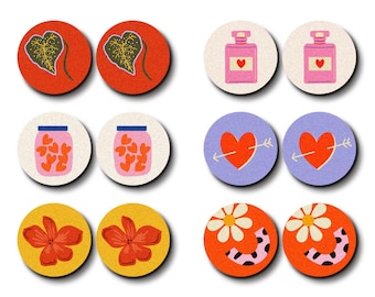May include: A selection of laser-cut wooden charms featuring diverse designs. The charms showcase botanical leaves, perfume bottles, jars of hearts, hearts with arrows, flowers, and smiley faces. The colour scheme includes red, orange, yellow, pink, purple, and white. The text "HALOCOLOR" and "Professional Laser Cut Wood Charm" are at the top.