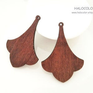 May include: Two brown wooden earrings shaped like a bell with a pointed top and a scalloped bottom.