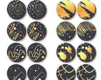 May include: Set of 12 laser cut wood circles with various gold and black patterns. The patterns include dots, lines, swirls, and splatters. The circles are approximately 2.5 cm in diameter.