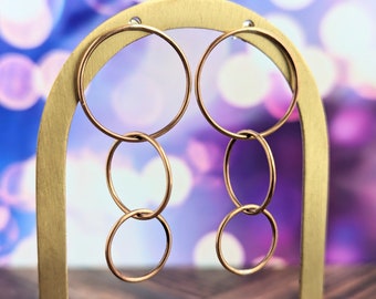 Long bronze infinity hoop earrings with sterling silver posts, intertwined geometric jewelry