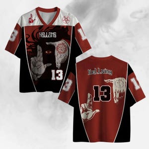 May include: A black, red, and white jersey with the word "HELLSING" and the number "13" printed on it. The jersey features a graphic of a person's hands and an eye. The sleeves have the number "3" and "1".