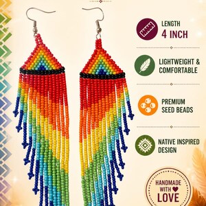 May include: A pair of handmade rainbow beaded earrings featuring a triangular top section and long, multi-colored fringe strands. The earrings measure 4 inches in length and are crafted with premium seed beads in a vibrant spectrum of colors.