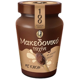 Peut inclure: Pot de tahini au cacao. Le pot marron est surmonté d'un couvercle marron foncé. L'étiquette indique "100" et "XRONIA MAZI". On peut également lire "Makedoniko tahini" et "ME KAKAO". Contient 350g de tahini.