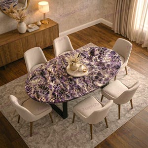 May include: An oval dining table with a striking purple and white patterned surface. The table is surrounded by six beige upholstered chairs with wooden legs. A decorative tray with a vase and candles sits on the table. The table is approximately 72 inches long.