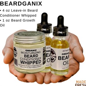 May include: A collection of beard care products, including a jar of whipped beard conditioner and two bottles of beard oil. The products are held in a person's hands. The labels read "BEARDGANIX" and "Organic".