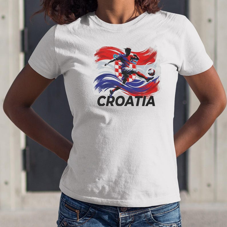 A white t-shirt with a graphic design depicting a soccer player in action, along with the word "Croatia" printed below.