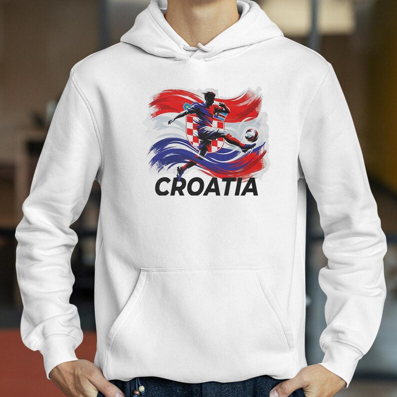 A white hoodie with a graphic design depicting a soccer player kicking a ball, with the word "Croatia" written below the image.
