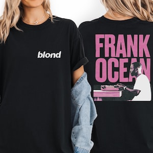 two people wearing black t-shirts with the text "blond" and "FRANK OCEAN" printed on them.