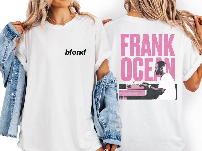 A woman wearing a white t-shirt with the word "blond" printed on it, standing next to a denim jacket.