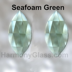 May include: Two seafoam green faceted glass teardrop shapes.  Seafoam Green.