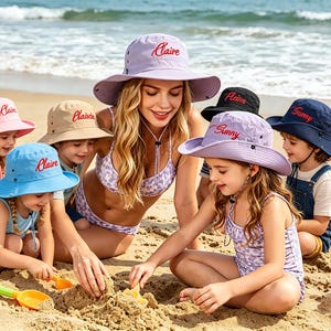 May include: A collection of wide-brimmed bucket hats in various colors including light purple, beige, light blue, black, and navy blue. Each hat features an adjustable chin strap and the embroidered name Claire or Sunny in red cursive script.