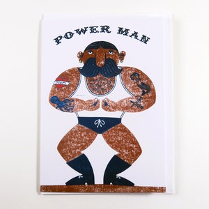 Powerman can lift any weight, and has mighty tattoos, from original lino print by Patrick Kennedy.