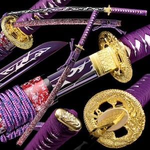 May include: A white ceramic mug with a black handle and the text "But First, Coffee" in a bold, black font. The mug is set against a blurred background, suggesting a cozy setting.