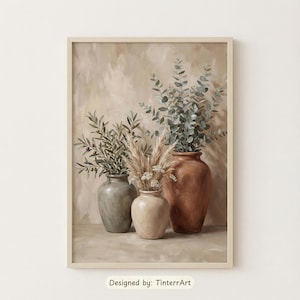 May include: A framed print featuring three vases with botanical arrangements. The vases are in shades of gray, beige, and terracotta. The arrangements include olive branches, pampas grass, and eucalyptus. The text "Designed by: TinterrArt" is at the bottom.