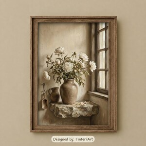May include: A framed wall art print featuring a bouquet of white peonies in a brown ceramic vase resting on a stone ledge next to a window. A small brown pitcher and a wooden scoop hang on the wall. The text Designed by: TinterrArt is visible.