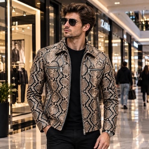 May include: A long-sleeve jacket featuring a brown and black snakeskin pattern, a pointed collar, and a full-length front zipper. The garment includes two horizontal zippered chest pockets and two lower zippered pockets, worn over a black shirt.