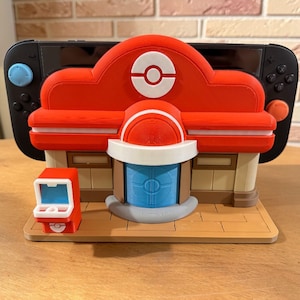 May include: A white ceramic mug with a black handle and the text "But First, Coffee" in a black, handwritten-style font. The mug is on a white surface.