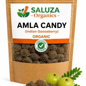 May include: A brown paper pouch of Saluza Organics Amla Candy with a clear window showing dark brown, sugar-coated sweets. The label features the text Saluza Organics, Amla Candy, Indian Gooseberry, and Organic. Two fresh green amla fruits sit nearby.
