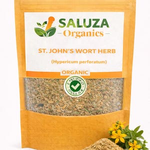 May include: A packet of St John's Wort Herb, labelled "Saluza Organics." The packet has a clear window showing the dried herb. A small pile of the herb and yellow flowers are in front of the packet.