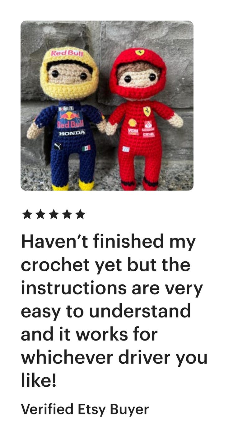 May include: Two handmade crochet dolls representing race car drivers. The left doll wears a yellow helmet and a dark blue racing suit with Red Bull and Honda logos. The right doll wears a red helmet and a red racing suit with Ferrari branding.