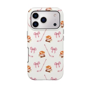 May include: White phone case with a repeating pattern of pink bows, hockey sticks, and stacks of books. The phone case has a white border and a camera cutout. The text "HOCKEY ROMANCE BOOK CASE" is on the right side.
