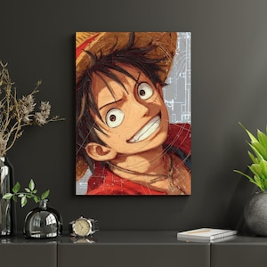 May include: A canvas print featuring a close-up of a smiling anime character with a straw hat. The character is wearing a red jacket and a necklace. The background has a light gray design.