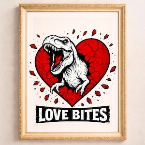 May include: Framed art print featuring a white Tyrannosaurus Rex bursting from a red heart with a cracked texture. The phrase "LOVE BITES" is printed in a black banner below the heart. The artwork is framed in a gold-colored frame.
