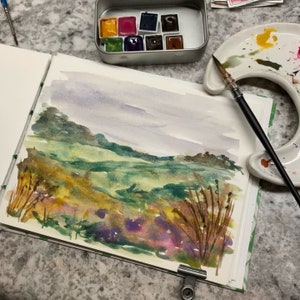 May include: A watercolor painting of a landscape with rolling hills, green fields, and a cloudy sky. The painting is done in shades of green, brown, and purple.