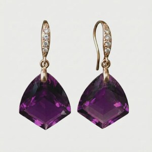 May include: A pair of gold-toned earrings featuring large, faceted, deep purple amethyst stones. The top portion of each earring has a curved design with small, clear gemstones.