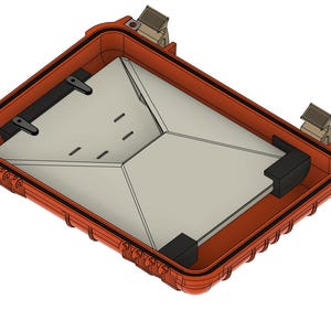 May include: An orange rectangular case with a light gray interior. The case has black corner protectors and latches. The interior has a geometric design with several small, rectangular cutouts.