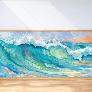 May include: A framed watercolor painting of a breaking ocean wave. The artwork features shades of turquoise, blue, and white, with hints of gold and yellow. The wave is captured in motion, with a foamy crest and a serene sky.