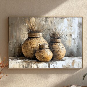 May include: A framed painting depicts three woven vases of varying sizes, filled with dried grasses. The vases are in shades of tan and brown, set against a textured, neutral-toned background. The artwork has a rustic, natural aesthetic.