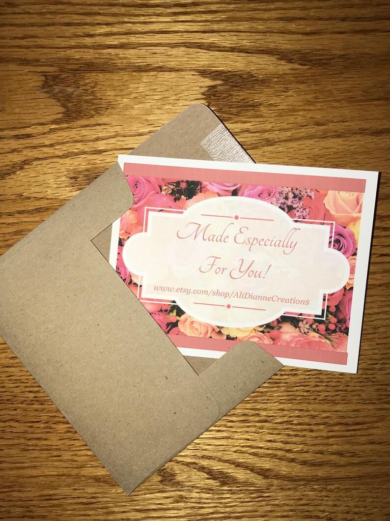 May include: A white card with a pink floral background and a white oval with the text "Made Especially For You!" and the website address "www.etsy.com/shop/AliDianneCreations". The card is in a brown envelope.
