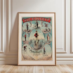 Peut inclure: Affiche encadrée vintage avec des illustrations de monocycle. L'affiche a un fond bleu sarcelle avec des vignettes ovales montrant des performances de monocycle. La bannière du titre indique "AUC COUCETT" et le texte "The Champion Monocyclist of the World" est également visible.