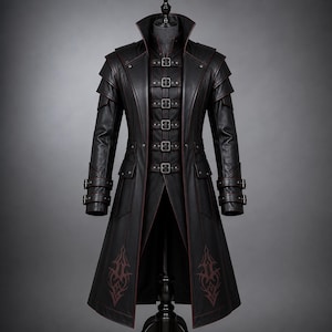 May include: A black long coat featuring a high collar, layered shoulder panels, and a front closure with six horizontal straps secured by metal buckles. The sleeves have double buckle cuffs, and the lower front panels display dark red decorative embroidery.