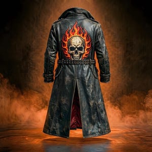 May include: Black leather duster coat with a skull and flame design on the back. The coat features a studded belt and collar, with a red interior lining. The coat is a long, vintage style.