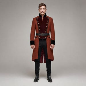 May include: A rust-colored long coat featuring a high collar, black velvet lapels, and two rows of gold-toned buttons. The coat includes a black belt with a rectangular buckle at the waist, black cuffs, and is worn over slim-fit black trousers and black boots.