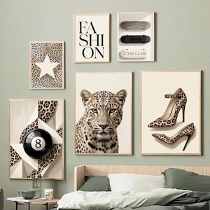 May include: A gallery wall set featuring six framed prints: a leopard print star, the word FASHION, three skateboards, a leopard portrait, a pair of leopard print high heels, and a geometric design with a black number eight billiard ball.