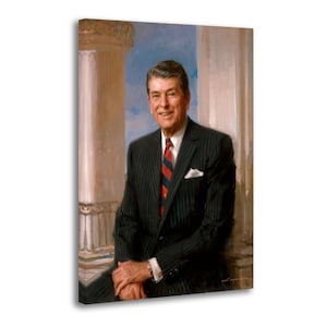 Puede incluir: Retrato de un hombre con traje de raya diplom&aacute;tica negro, con corbata a rayas rojas y azules, pa&ntilde;uelo blanco y camisa de cuello blanco. El fondo presenta un cielo azul claro y columnas blancas. El hombre est&aacute; sonriendo.