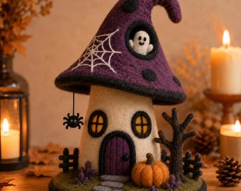 May include: A needle-felted mushroom house with a purple cap featuring a white spiderweb and a small ghost in a window. The cream-colored stem has a purple door, two yellow windows, a hanging black spider, a pumpkin, and a dark tree.