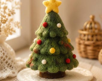 May include: A needle-felted green Christmas tree ornament featuring a yellow star topper and small, round, multi-colored felted balls in red, white, and yellow scattered across the branches, set upon a brown felted base.