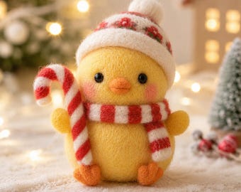 May include: A needle-felted yellow chick figurine wearing a white and red patterned winter hat and a matching red and white striped scarf. The chick holds a red and white striped candy cane in one wing and has small orange feet.