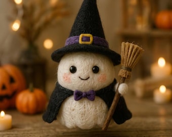 May include: A needle-felted white ghost figurine wearing a black witch hat with a purple band and yellow buckle, a black cape, and a purple bow tie. The ghost has rosy cheeks and holds a small brown broomstick made of natural fibers in its hand.