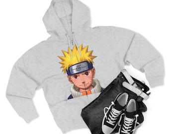 May include: A light gray zip-up hoodie featuring a colorful graphic of an anime character with spiky yellow hair and a blue headband. The hoodie is paired with black jeans, a white belt, and black and white sneakers.