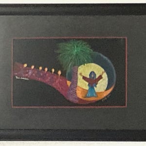 May include: A framed painting on a black background featuring a figure in a blue and red robe standing within a yellow circle. A green palm tree stands beside the figure, and a purple path with small orange lights extends to the left side.