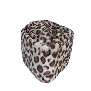May include: A leopard print hat with a cream-colored base and brown spots. The hat is made of a soft, textured material and has a rounded shape. The hat is a fashion accessory.
