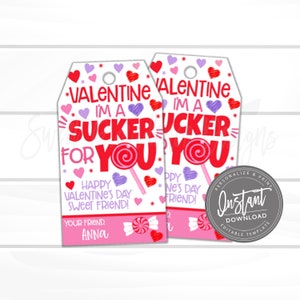 May include: Two printable Valentine's Day gift tags with a pink and white background. The tags feature a red and white lollipop with the text "I'm a sucker for you" and hearts. The text "Happy Valentine's Day Sweet Friend!" and "Your Friend, Anna" are also included.