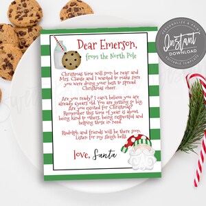 May include: A Christmas-themed letter from Santa to Emerson, with a green and white striped border. The letter includes a drawing of milk and cookies, and a Santa Claus illustration. Chocolate chip cookies and candy canes are also visible.