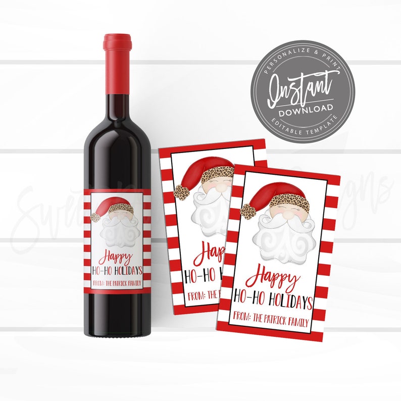 May include: A bottle of red wine with a label featuring a Santa Claus design and the text "Happy HO-HO Holidays." Two matching gift tags are next to the bottle, with the same Santa design and text.