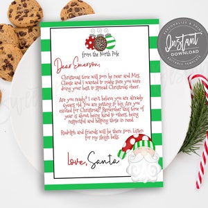 May include: A personalised Christmas letter from Santa, with a green and white striped border and festive illustrations. The letter includes the text "Dear Emerson" and "love, Santa", with chocolate chip cookies and candy canes.